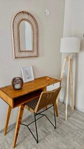 a wooden desk with a chair and a mirror at BOSQUE LIBERTAD Casa Planta Baja in Mar Azul +10 photos