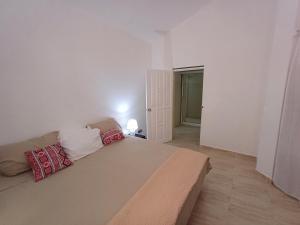 a bedroom with a large bed with two pillows on it at Linkzup Playa Laguna Villa in Sosúa +26 photos