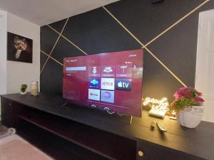 a flat screen tv sitting on top of a table at Linkzup Playa Laguna Villa in Sosúa
