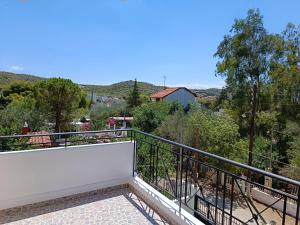a balcony with a view of trees and mountains at AROKARIA HOUSE in Kanakia