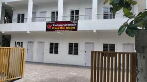 a building with a sign that reads urgent risk benefits at Dream Nest Resort in Mettuppālaiyam