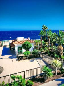 a view of a house with the ocean in the background at Atlantic View Tenerife South in Arona
