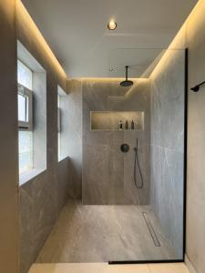 a bathroom with a shower with a glass door at Old town luxury apartment 3 in Kos Town