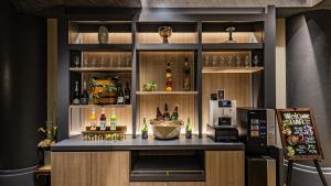 a bar in a restaurant with a counter with drinks at Hotel Quest Shimizu in Shizuoka