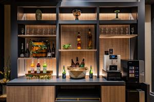 a bar in a kitchen with bottles of alcohol at Hotel Quest Shimizu in Shizuoka