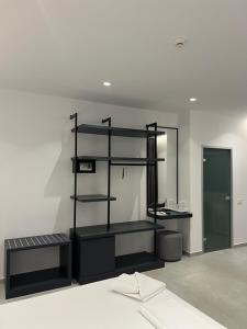 a bathroom with a black shelf in a room at Adele Hotel Ksamil in Ksamil
