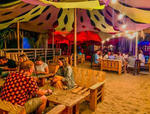 a group of people sitting at tables in a restaurant at Zaigon Kite Surf in Máncora +37 photos