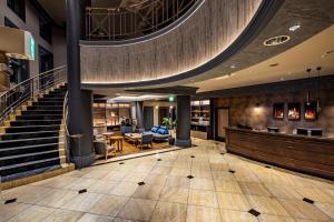 a lobby of a hotel with a spiral staircase at Hotel Quest Shimizu in Shizuoka