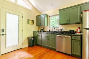 a kitchen with green cabinets and a large window at Crows Nest Luxury Near Asheville in Marshall