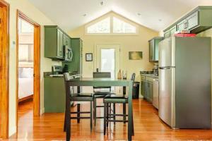 a kitchen with green cabinets and a table and a refrigerator at Crows Nest Luxury Near Asheville in Marshall +20 photos