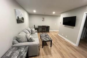 a living room with a couch and a table at Aksarben Apt-Cozy One Bedroom in Omaha