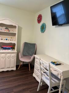 a room with a desk and a chair and a tv at The Diamond Escape , Home in murfreesboro in Murfreesboro