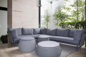 a living room with a couch and two tables and stools at Condo con Alberca a un Paso del Estadio Azteca in Díaz