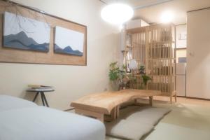 Postel nebo postele na pokoji v ubytování Saku House Jujo