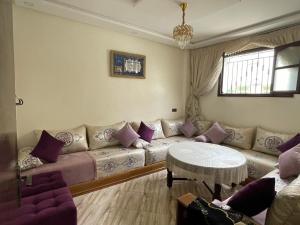 a living room with a couch and a table at Appartement agadir in Agadir +1 photo