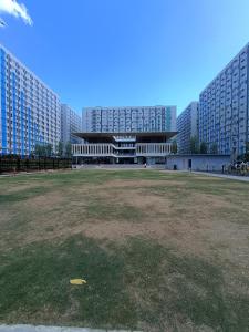 a large building with a large field in front of it at SleepScape Staycation in Manila +8 photos