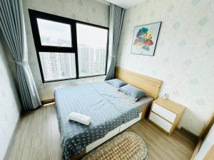 a small bedroom with a bed and a window at OceanPark Amazing Cozy Modern great view 3Beds in Gia Lâm Pho +36 photos