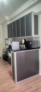 a kitchen with a counter top and a microwave at Humaira Dian Residency Studio Homestay 360sqft in Shah Alam