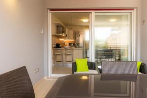 ein Wohnzimmer mit Tisch und Stühlen und eine Küche in der Unterkunft 100 m from the beach with CABANA and JACUZZI included in Lignano Sabbiadoro