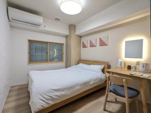 Postel nebo postele na pokoji v ubytování Nikko Beans Hotel