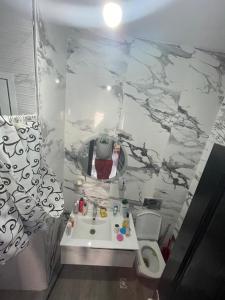 a bathroom with a sink and a toilet at أكر أزكواغ in Al Hoceïma