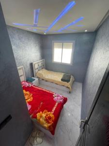 a small room with a bed and a window at أكر أزكواغ in Al Hoceïma