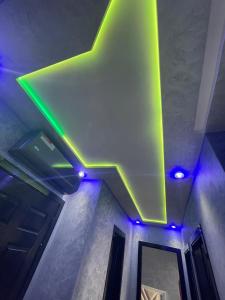 a green and white star on the ceiling of a room at أكر أزكواغ in Al Hoceïma
