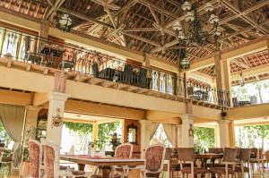 a large room with tables and chairs and a balcony at Kayu Arum Resort in Salatiga