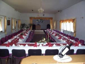 a large room with a long table with red bows at Haus Waldesruh in Petersdorf