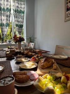 a table topped with plates of food and fruit at Guest House Hello in Kutaisi