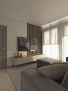a living room with a television and a couch at great apartment in Madrid complex in Kirovo