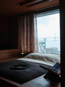 Uma cama ou camas num quarto em After Chapter Hotel Gwanganri