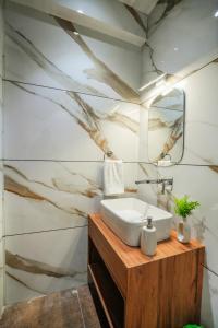 a bathroom with a sink and a mirror at SaffronStays Bourbon in Bhīm Tāl