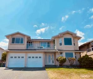 a large house with two garage doors at Ocean View Home Nanaimo in Nanaimo