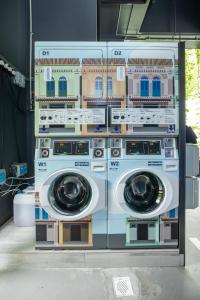 three washing machines stacked on top of each other at Hotel Faber Park Singapore - Handwritten Collection in Singapore