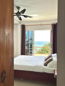 a bedroom with a bed and a large window at Aqua Sunset Gulhi Island, Maldives in Gulhi +71 photos