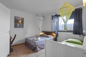a bedroom with two beds and a window at Villa Belle Etoile in Le Vauclin +17 photos