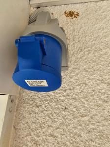 a blue trash can sitting on a carpeted floor at Apartment Stula in Omišalj