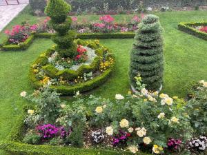 a garden with two fountains and flowers at City Garden in Kolašin