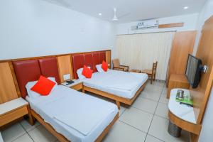 Postel nebo postele na pokoji v ubytování Hotel Janardana
