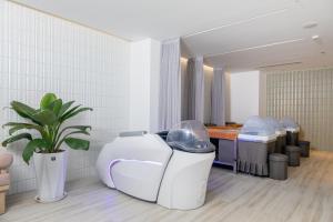 a room with three trash cans and a table at Awaken Da Nang Hotel in Danang
