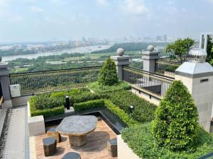 a garden with a bench on top of a building at Roomio Paris Hoang Kim-Shared Apartment in Ho Chi Minh City