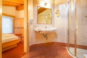 a bathroom with a sink and a shower at Hotel Daniel Apartments in Selva +21 photos