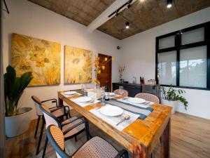 a dining room with a large wooden table and chairs at Casa Monte in Cagayan de Oro