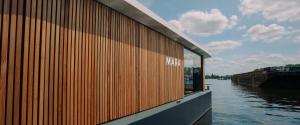 a wooden wall on the side of a body of water at Spreeapartment MARA in Berlin