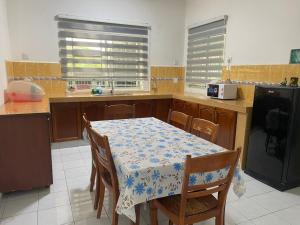 a kitchen with a table with a blue and white table cloth at NZ Homestay in Melaka