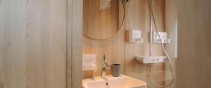 a bathroom with a sink and a shower at Spreeapartment MARA in Berlin +7 photos
