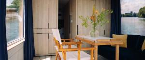 a small table with a vase of flowers on it at Spreeapartment MARA in Berlin