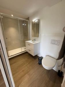 a bathroom with a shower and a toilet and a sink at Gites du Manoir de Kergoniou Saint Joseph in Paimpol