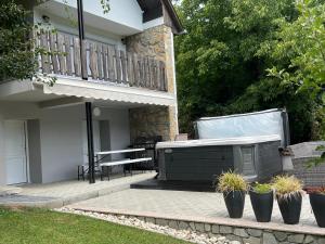 a hot tub sitting on a patio next to a house at Légy Ott Kuckó in Zalaszentlászló